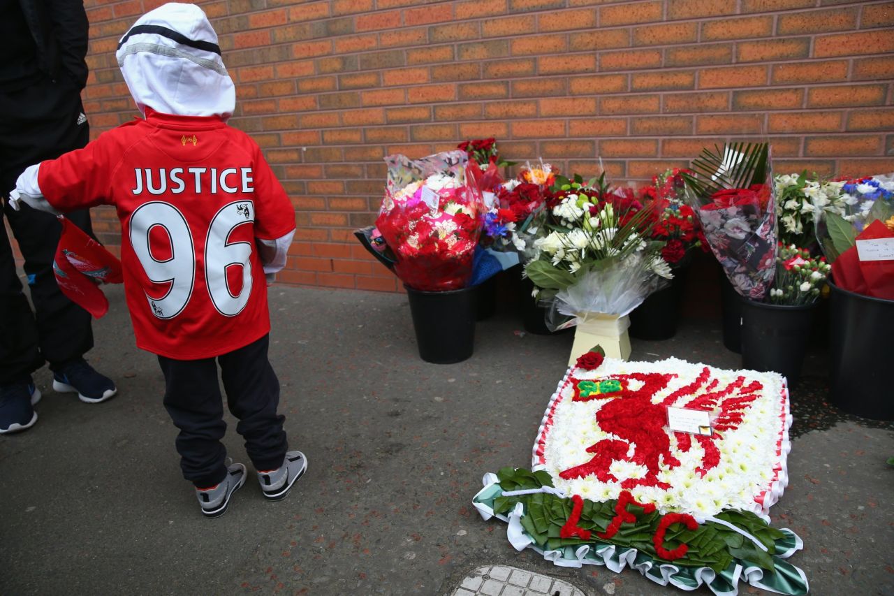 The young fan wears a shirt calling for justice for the 96 victims.