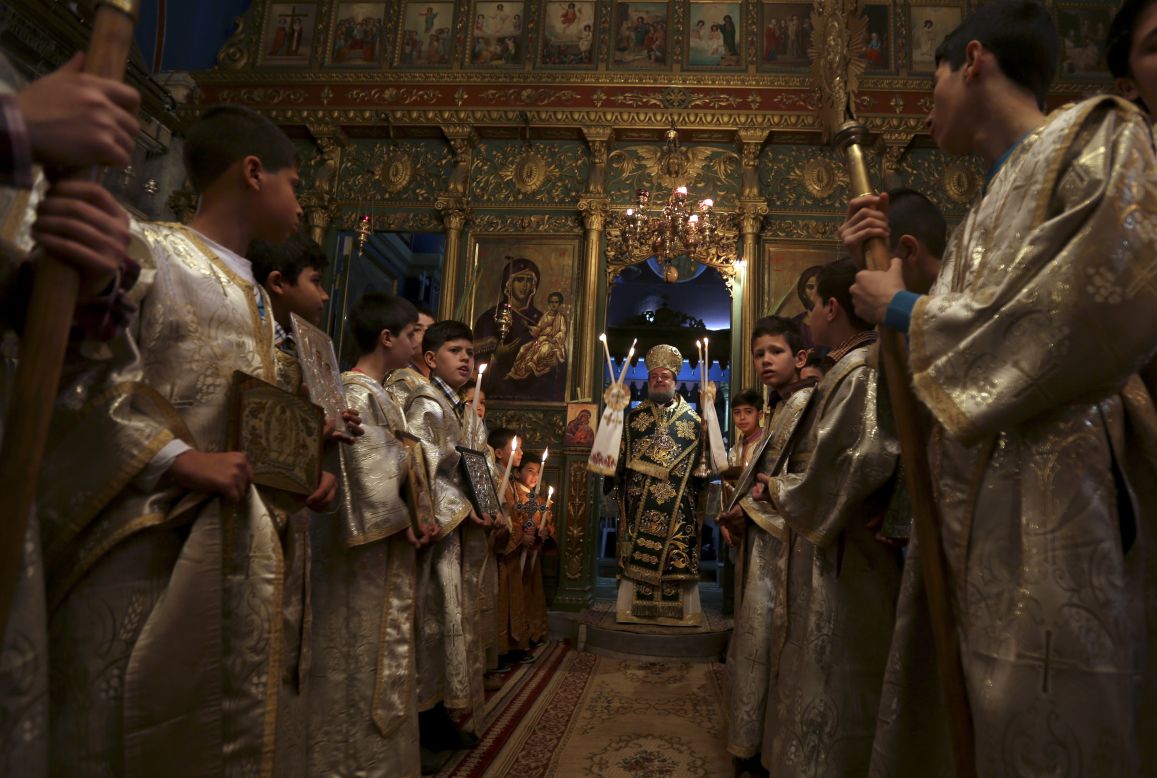 BETHLEHEM, WEST BANK: The head of the Greek Orthodox church, Bishop Theofilactos, holds the Palm Sunday mass at the Church of the Nativity on April 13. <a href="http://www.cnn.com/video/data/2.0/video/world/2014/04/14/jerusalem-palm-sunday.cnn.html">CNN spoke to Christians celebrating in Syria and Palestine.</a>