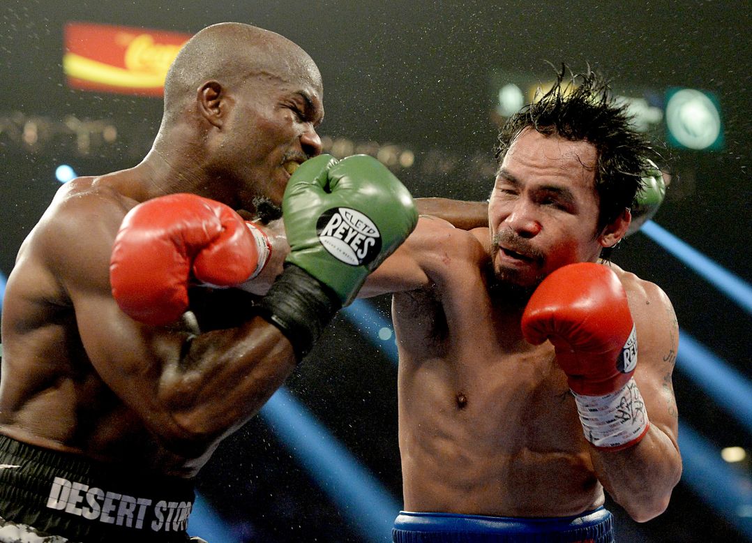 Timothy Bradley, left, and Manny Pacquiao clash during their welterweight title fight in Las Vegas on Saturday, April 12. Pacquiao won by unanimous decision, avenging a controversial loss to Bradley in 2012.