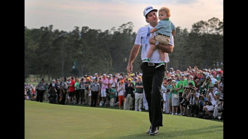 Pro golfer Bubba Watson holds his son, Caleb, after winning the Masters tournament on Sunday, April 13, in Augusta, Georgia. It was the second Masters win for Watson, who also won the major in 2012.