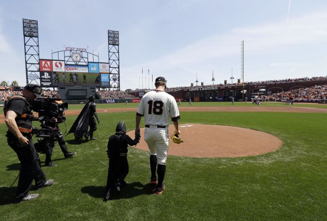 Miles Scott, dressed as Batkid, walks to the mound with San Francisco Giants pitcher Matt Cain before <a href="http://www.cnn.com/2014/04/09/us/gallery/batkid-throws-first-pitch/index.html">throwing out the ceremonial first pitch</a> at the Giants' home opener on Tuesday, April 8. Miles, a 5-year-old who has been fighting leukemia since he was a baby, made headlines in November when, through the Make-A-Wish Foundation, he became Batman for a day and got to "save" the city.