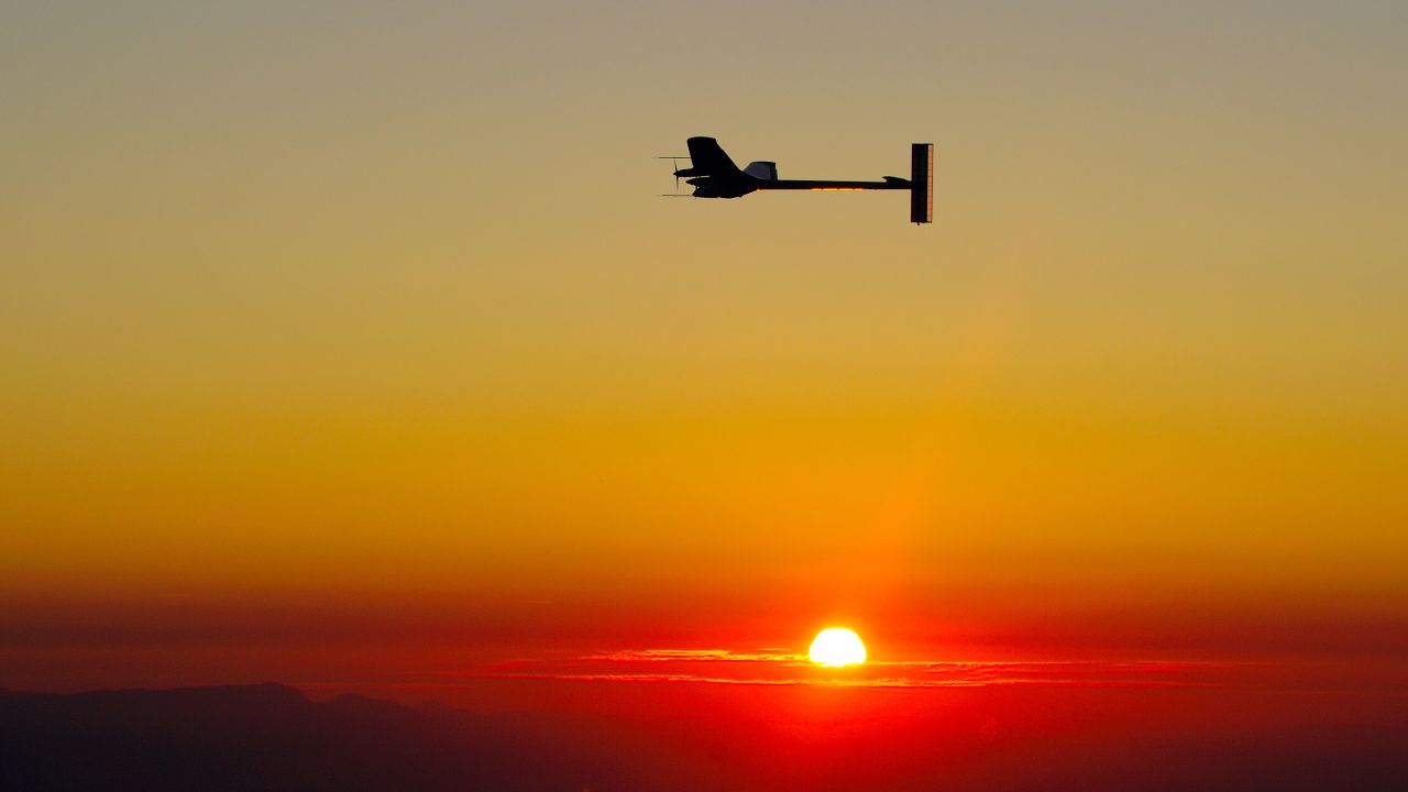 Experimental aircraft 'Solar Impulse' with pilot Andre Borschberg onboard flies at sunrise above Payerne's Swiss airbase on July 8, 2010 during the first attempt to fly around the clock fuelled by nothing but the energy of the sun. The solar powered aircraft was flying in circles high over Switzerland at first light well on its way to completing a historic round the clock flight. AFP PHOTO / FABRICE COFFRINI (Photo credit should read FABRICE COFFRINI/AFP/Getty Images)