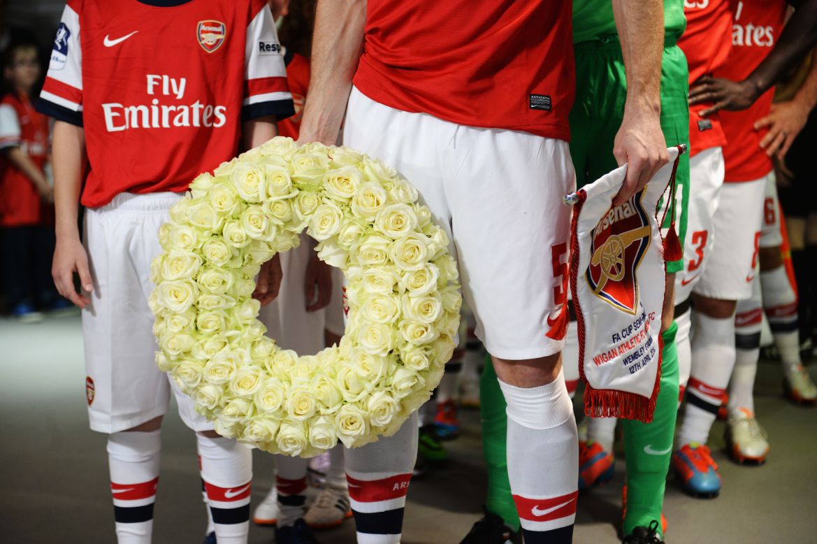 Prior to the FA Cup semifinal match between English soccer clubs Arsenal and Wigan Athletic, Arsenal captain Thomas Vermaelen holds a commemorative wreath to mark the 25th anniversary of the Hillsborough disaster. In 1989, before an FA Cup semifinal, 96 fans of Liverpool Football Club were crushed to death by an overflow at Hillsborough Stadium in Sheffield, England.