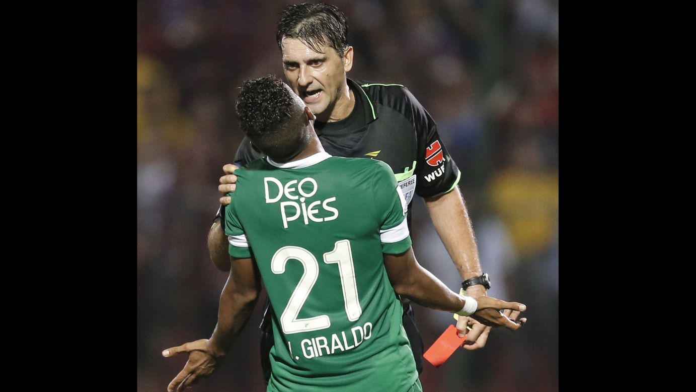 Victor Hugo Giraldo, a soccer player with Colombian club Deportivo Cali, protests a penalty called by referee Dario Ubriaco during a Copa Libertadores match Tuesday, April 8, against Paraguayan club Cerro Porteno. Cerro Porteno won the match 3-2 in Asuncion, Paraguay, advancing to the knockout stage of the tournament.