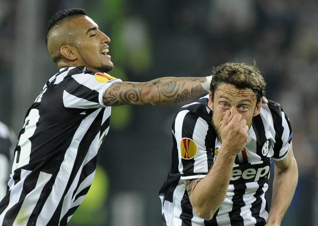 Juventus midfielder Claudio Marchisio, right, celebrates with teammate Arturo Vidal after scoring a goal against Lyon during the second leg of their Europa League quarterfinal Thursday, April 10, in Turin, Italy. Juventus won the game 2-1 and advanced to the semifinals of the European soccer tournament. 