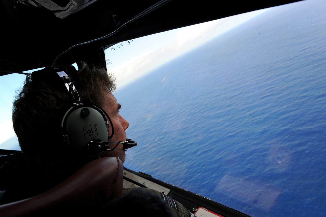 A member of the Royal New Zealand Airforce flies over the Indian Ocean during the search for MH 370. 
