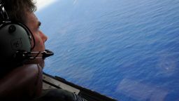 IN FLIGHT - APRIL 11: Co-pilot and Squadron Leader Brett McKenzie of the Royal New Zealand Airforce (RNZAF) P-3K2-Orion aircraft, helps to look for objects during the search for missing Malaysia Airlines flight MH370 in flight over the Indian Ocean on April 13, 2014 off the coast of Perth, Australia. Search and rescue officials in Australia are confident they know the approximate position of the black box recorders from missing Malaysia Airlines Flight MH370, Australian Prime Minister Tony Abbott said on Friday. At the same time, however, the head of the agency coordinating the search said that the latest 'ping' signal, which was captured by a listening device buoy on Thursday, was not related to the plane. (Photo by Greg Wood - Pool/Getty Images)