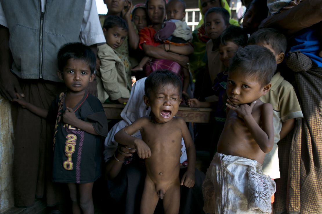 Rohingya children displaced by violence wait for medical care at a camp in Rakhine.