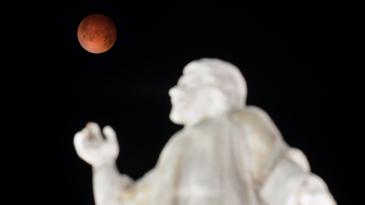 A "blood moon" rises over the El Salvador del Mundo monument in San Salvador early Tuesday, April 15, 2014, as a total lunar eclipse attracts sky gazers across the Americas. In a total lunar eclipse, the full moon turns a coppery red as it passes into Earth's shadow. "It's like seeing all the sunsets on Earth projected on the moon at once," says Indra Petersons of CNN's "New Day."
