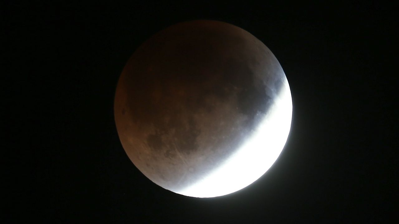 The Earth's shadow crosses over the last bit of reflected light on the moon's surface.