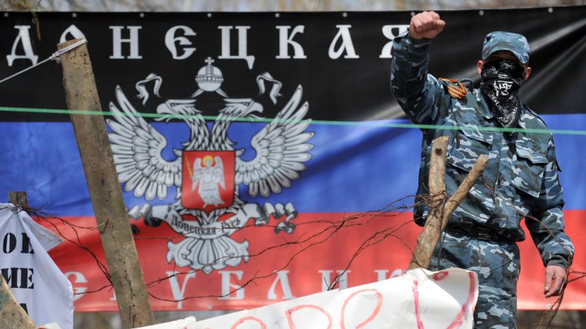 A pro-Russia activist gestures as he guards a barricade outside the regional police building in the eastern Ukrainian city of Slavyansk on April 15, 2014.