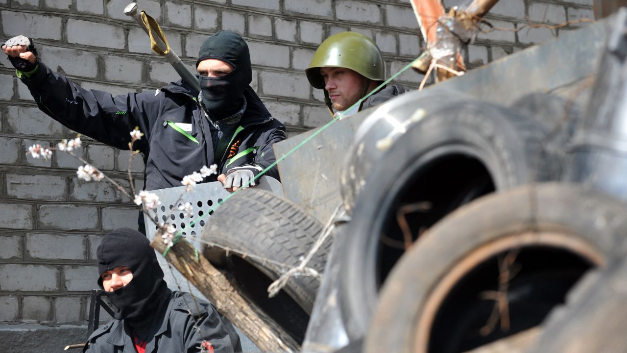 Pro-Russian activists guard a barricade April 15 outside the regional police building that they seized in Slovyansk.