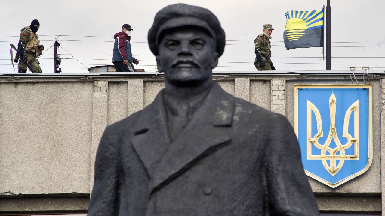 Armed pro-Russian activists stand guard on top of a Ukrainian regional administration building in Slovyansk on Monday, April 14.