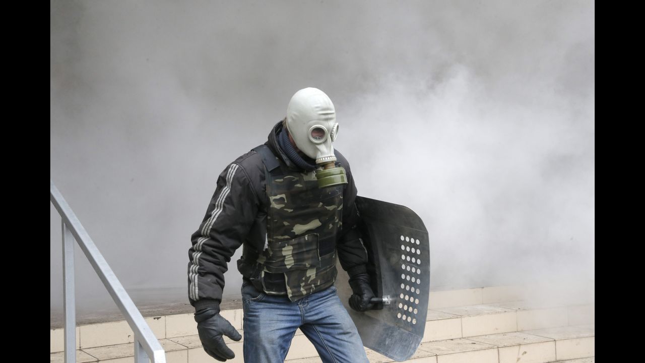A pro-Russian activist carries a shield during the mass storming of a police station in Horlivka, Ukraine, on April 14.