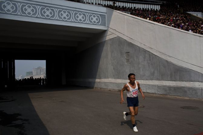 An elderly North Korean man enters Kim Il Sung Stadium on the last stretch of his run.