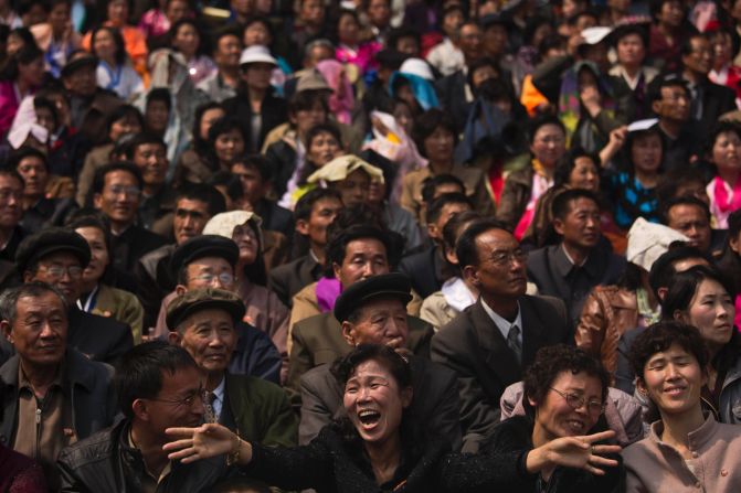 North Korean spectators watch and cheer from the stands of Kim Il Sung Stadium as runners arrive at the finish of the Mangyongdae Prize International Marathon.