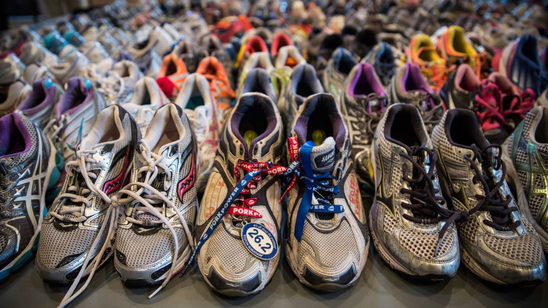 Running shoes are laid out in a display at the Boston Public Library. It's called "Dear Boston: Messages from the Marathon Memorial."