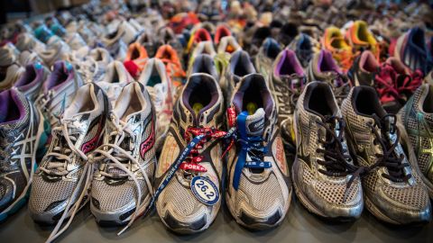 Running shoes are laid out in a display at the Boston Public Library. It's called "Dear Boston: Messages from the Marathon Memorial."