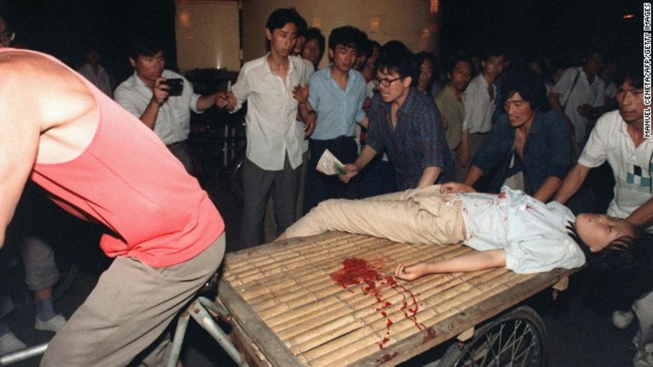 A girl wounded during the military crackdown in Beijing on June 4, 1989, is carried away on a bicycle cart.