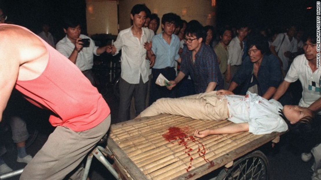 A girl wounded during the military crackdown in Beijing on June 4, 1989, is carried away on a bicycle cart.