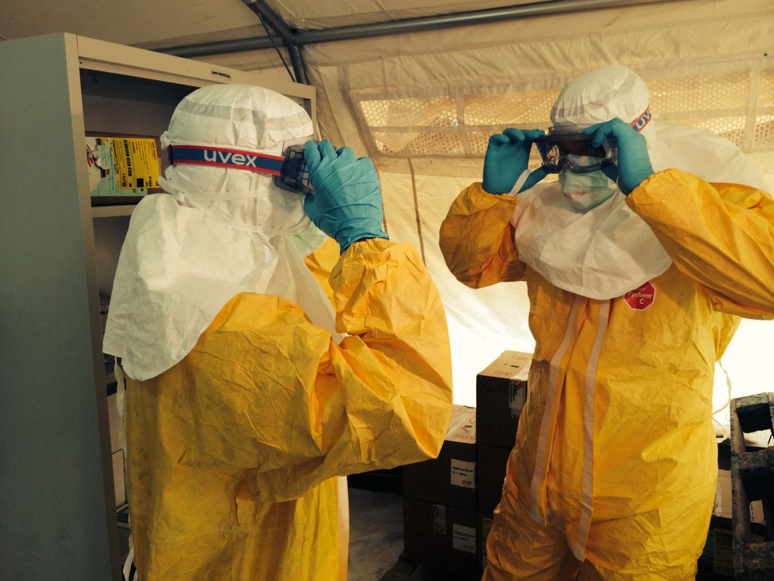 Drs. Sanjay Gupta, left, and Tim Jagatic don isolation gear outside an Ebola ward in Conakry, Guinea.