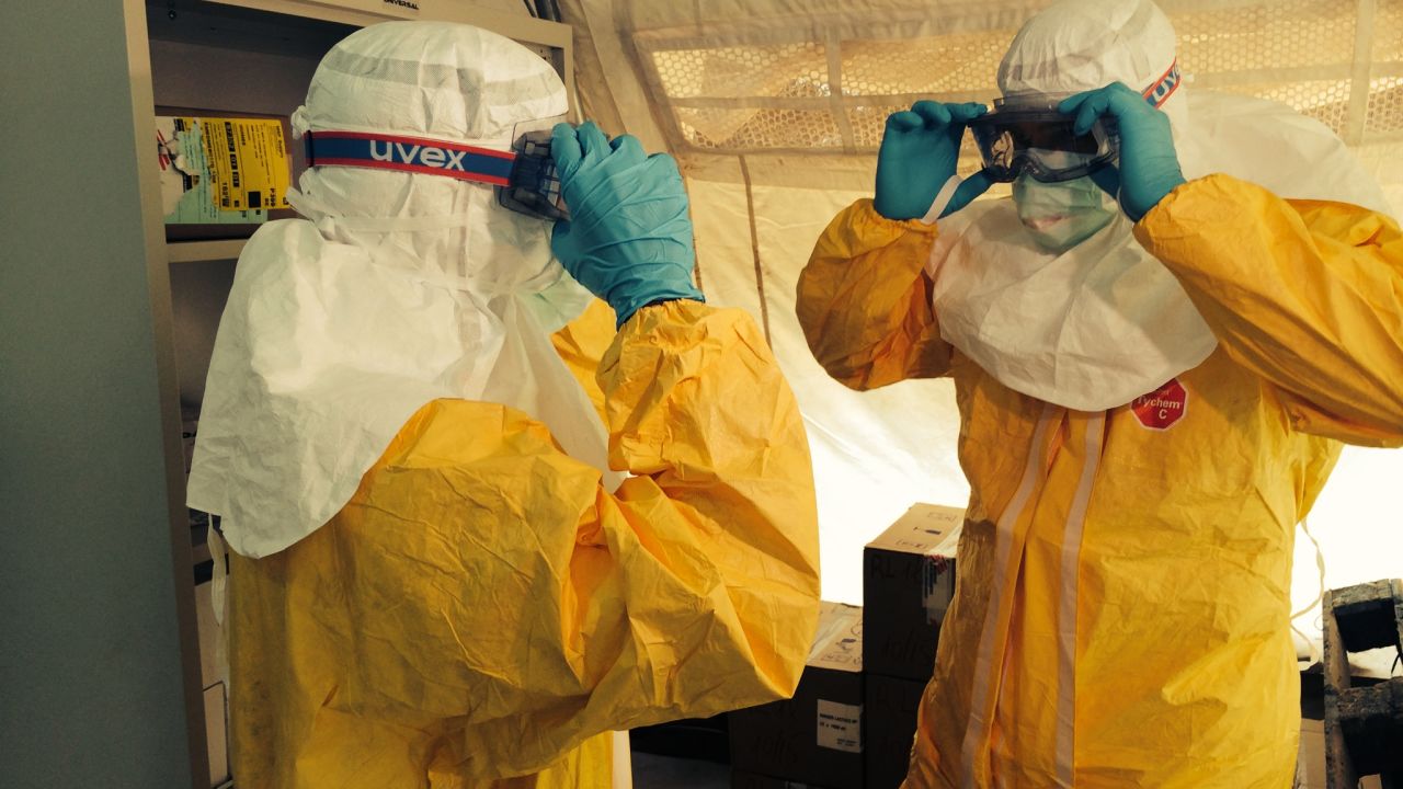 Drs. Sanjay Gupta, left, and Tim Jagatic don isolation gear outside an Ebola ward in Conakry, Guinea.