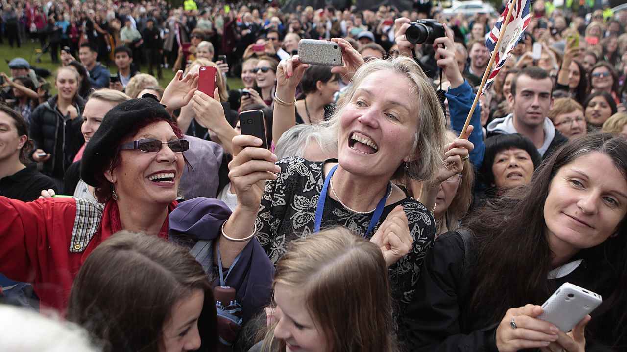 New Zealanders wait to see the royal family at Wellington's Civic Square on April 16.