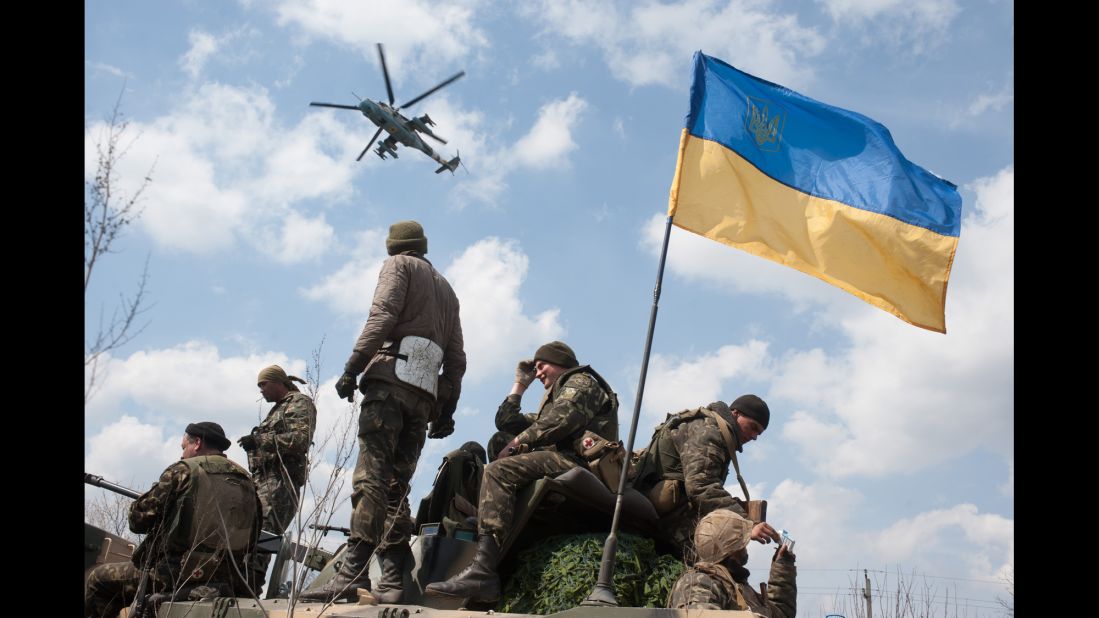 A Ukrainian helicopter flies over a column of Ukrainian Army combat vehicles on the way to Kramatorsk on April 16.