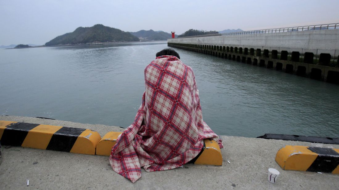 A relative waits for a missing loved one at the port in Jindo.