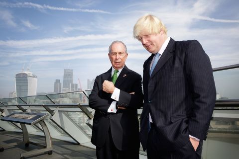 London Mayor Boris Johnson talks with Bloomberg on the balcony of London's City Hall after launching the Mayors Challenge in Europe. The Mayors Challenge is a competition, with prize money coming from Bloomberg's philanthropic foundation, that challenges cities to find innovative and creative ideas to solve problems faced by urban living. 