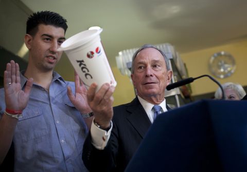 Bloomberg holds a large cup as he speaks to the media about the health impacts of sugar in March 2013.