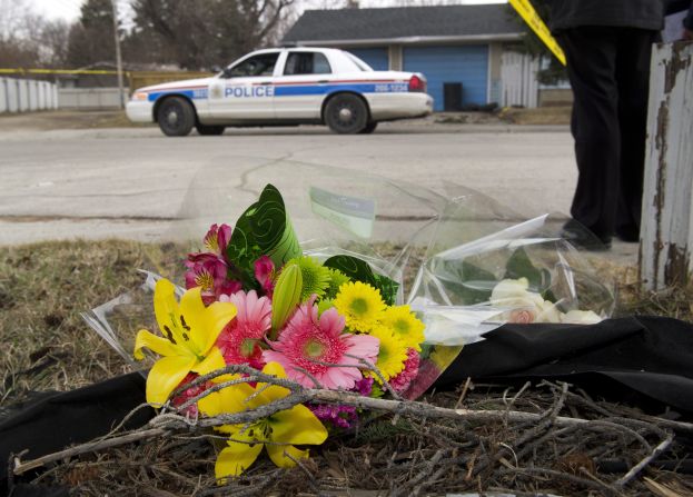 A makeshift memorial is left at police tape line near the scene of the multiple fatal stabbing.