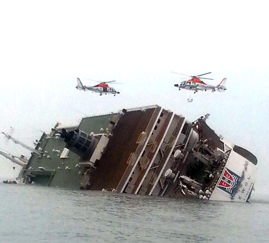 Helicopters hover over the ferry as rescue operations continue April 16.