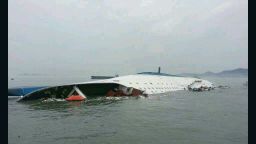 Caption:JINDO-GUN, SOUTH KOREA - APRIL 16: In this handout image provided by the Republic of Korea Coast Guard, a passenger ferry sinks off the coast of Jindo Island on April 16, 2014 in Jindo-gun, South Korea. The ferry identified as the Sewol was carrying about 470 passengers, including students and teachers, traveling to Jeju island. (Photo by The Republic of Korea Coast Guard via Getty Images)