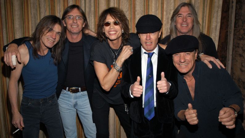 Steven Tyler of Aerosmith, center, poses with AC/DC at the Rock and Roll Hall of Fame induction ceremony in 2003.