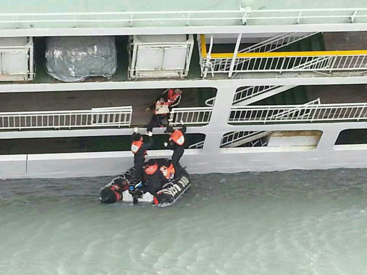 A passenger is helped onto a rescue boat on April 16.