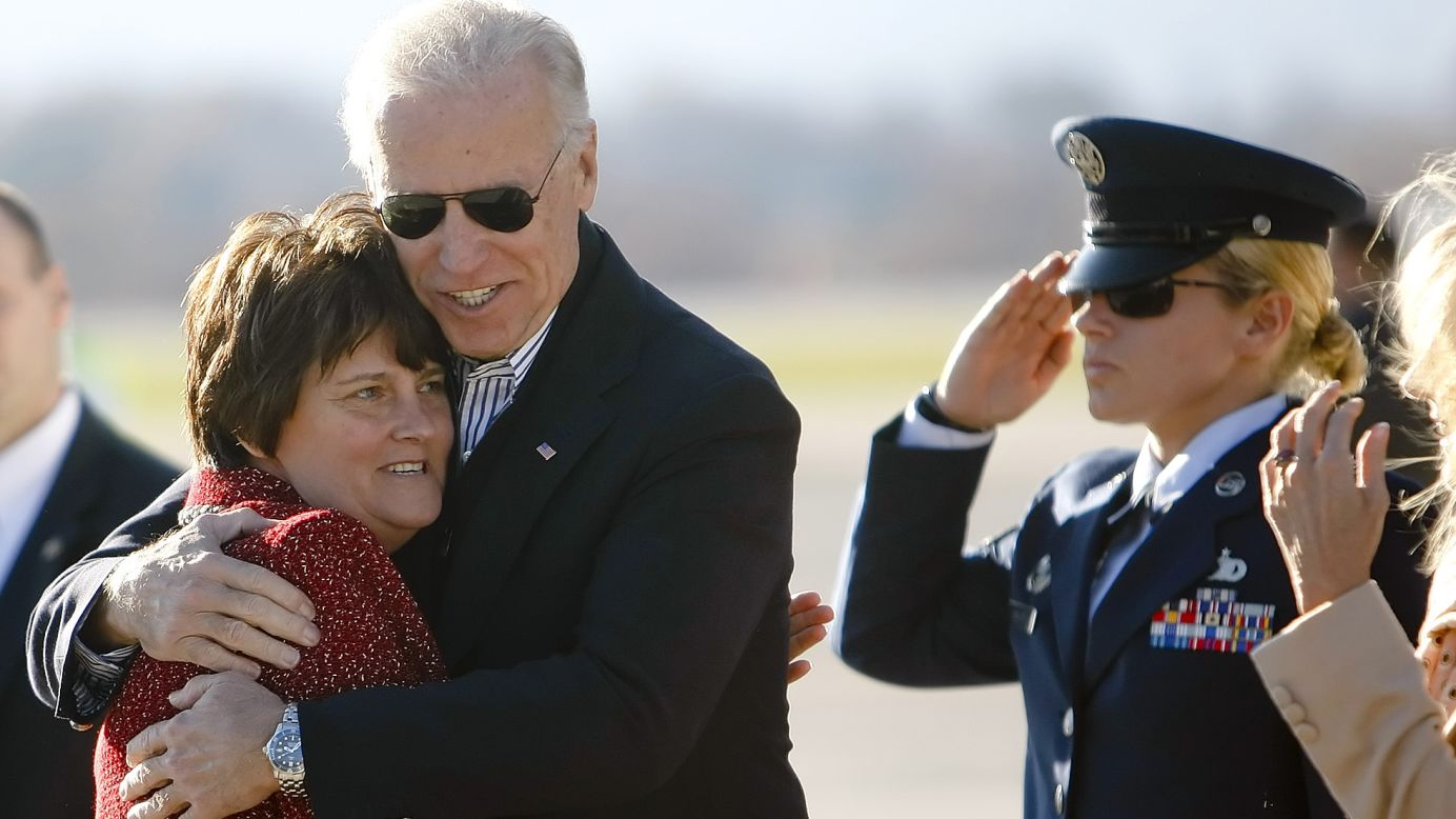 Biden hugs Anne Holton, wife of U.S. Sen. Tim Kaine, on a tarmac in Roanoke, Virginia, in November 2012.