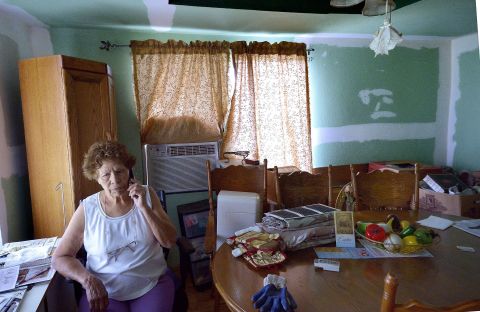 Eleanor Castro sits in her home in West, Texas. Her property was damaged by the <a href="http://www.cnn.com/2013/04/18/us/gallery/texas-explosion/index.html">fertilizer plant explosion</a> a year ago that claimed 15 lives.