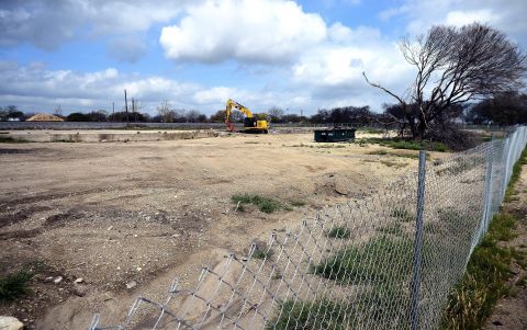 A fence surrounds the barren site of West Fertilizer Co. Twelve months later, authorities haven't pinpointed the cause of the blast.