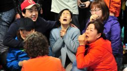 South Korean relatives of passengers on board a capsized ferry cry as they wait for news about their loved ones, at a gym in Jindo on April 17, 2014. The frantic search for nearly 300 people, most of them schoolchildren, missing after a South Korean ferry capsized extended into a second day on April 17, as distraught relatives maintained an agonising vigil on shore. AFP PHOTO / JUNG YEON-JE (Photo credit should read JUNG YEON-JE/AFP/Getty Images)