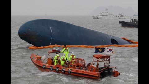 South Korean coast guard members and rescue teams search for passengers at the site of the sunken ferry on April 17.