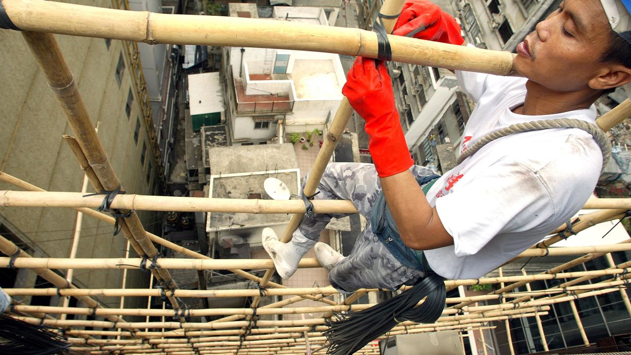 Hong Kong's scaffolders dangle precariously on bits of bamboo.