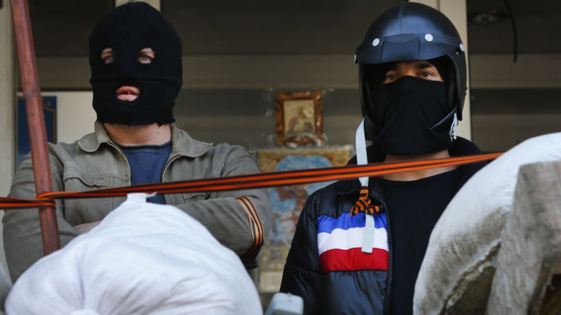 Masked pro-Russian protesters stand guard in front of the city hall in Mariupol on April 17.