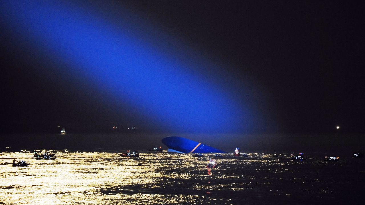 A searchlight illuminates the capsized ferry on Thursday, April 17.