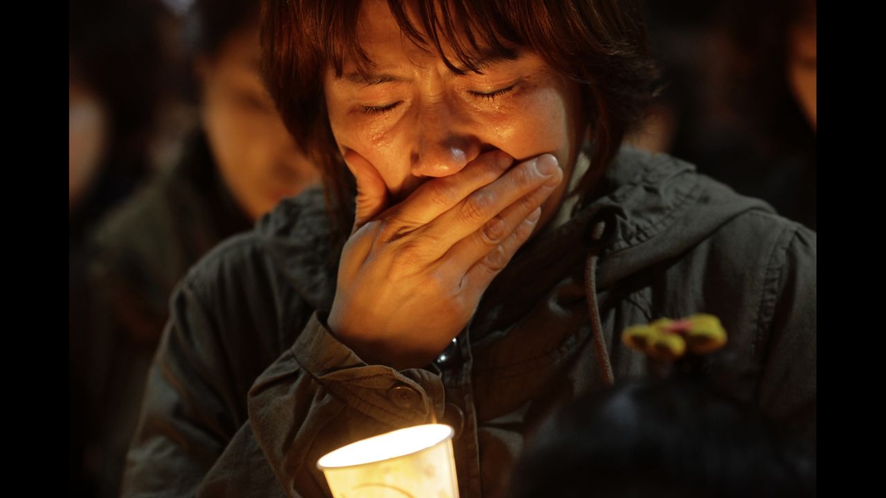 A woman cries during a candlelight vigil at Danwon High School in Ansan, South Korea, on April 17.