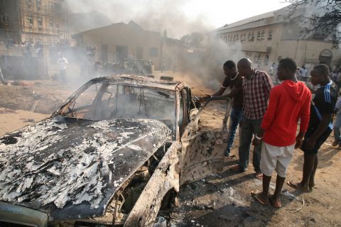 Men look at the wreckage of a car after a bomb blast at St. Theresa Catholic Church outside Abuja on December 25, 2011. A string of bombs struck churches in five Nigerian cities,<a href="http://www.cnn.com/2011/12/25/world/africa/nigeria-church-bombing/index.html"> leaving dozens dead and wounded on the Christmas holiday</a>, authorities and witnesses said. Boko Haram's targets included police outposts and churches as well as places associated with "Western influence."