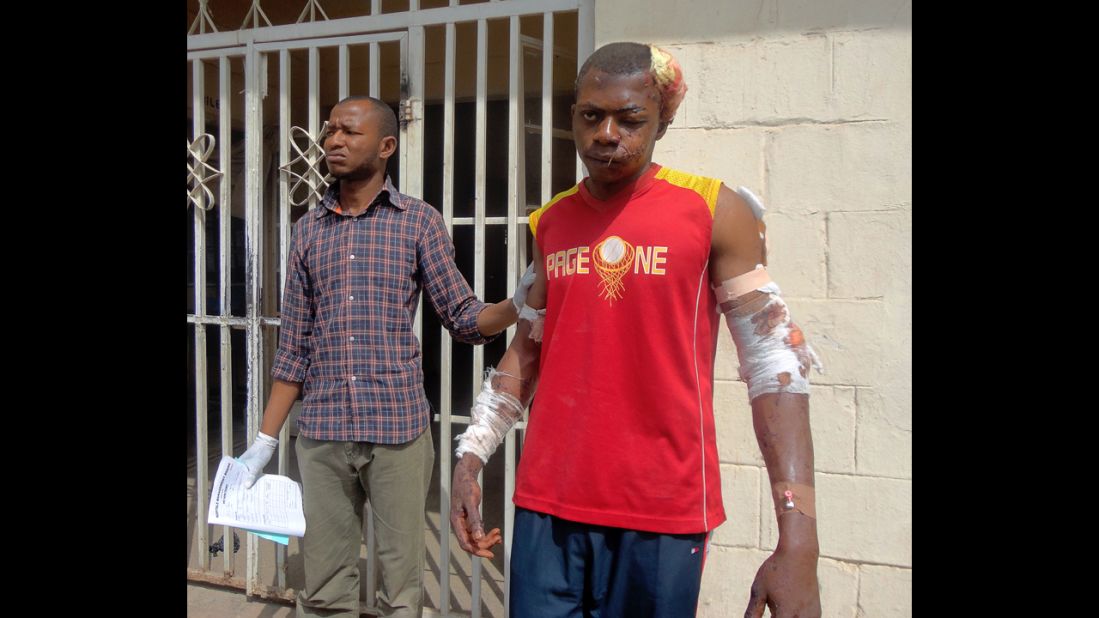 A paramedic helps a young man as he leaves a hospital in the northern Nigerian city of Kano on January 21, 2012. A spate of bombings and shootings left more than 200 people dead in Nigeria's second-largest city. Three days later, a joint military task force in Nigeria <a href="http://www.cnn.com/2012/01/24/world/africa/nigeria-attacks/">arrested 158 suspected members</a> of Boko Haram.