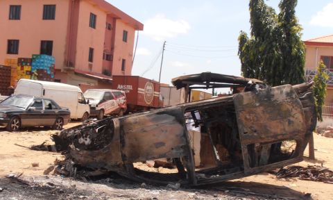 A photo taken on June 18, 2012, shows a car vandalized after three church bombings and retaliatory attacks in northern Nigeria killed at least 50 people and injured more than 130 others, the Nigerian Red Cross Society said. 
