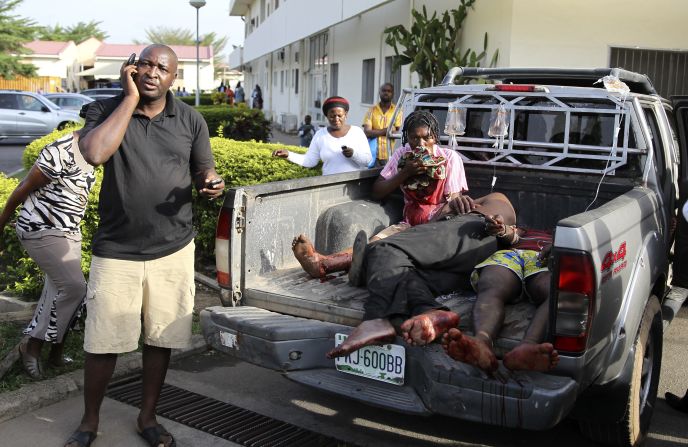 Injured victims of a <a href="http://www.cnn.com/2014/04/14/world/gallery/nigeria-bus-station-blast/index.html">bomb attack</a> wait in the back of a pickup truck near a hospital in Abuja, Nigeria, on Monday, April 14. Dozens of people were killed and more than 100 were injured after a parked vehicle exploded at the Nyanya Motor Park bus station, Nigerian officials said.
