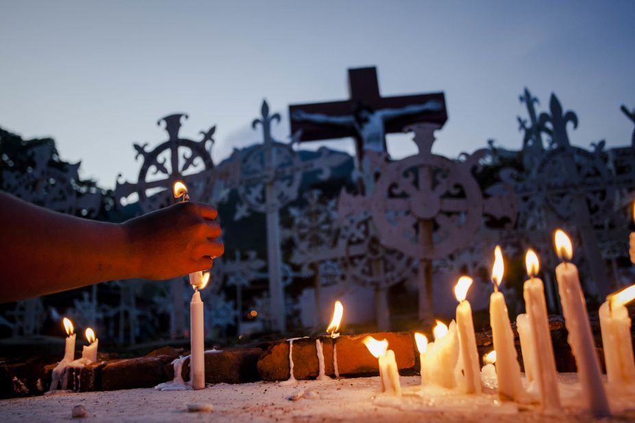 A Catholic worshipper lights a candle at the tombs of ancestors during Holy Week celebrations known as Semana Santa on April 16, in Larantuka, East Nusa Tenggara, Indonesia.